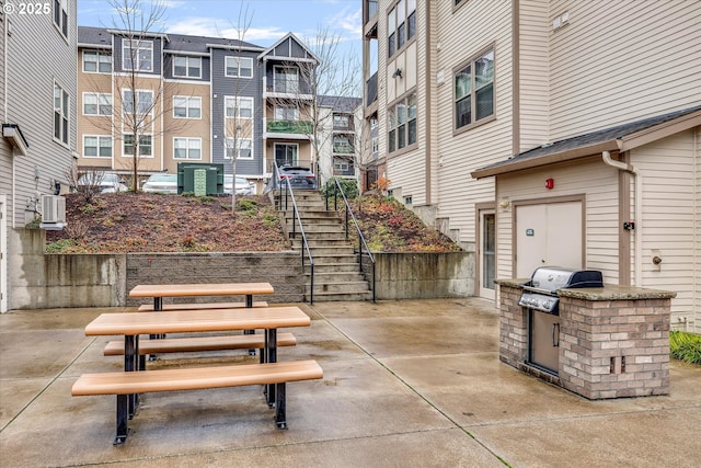 view of community with a patio and exterior kitchen