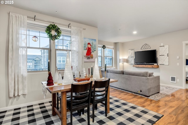 dining space with hardwood / wood-style flooring