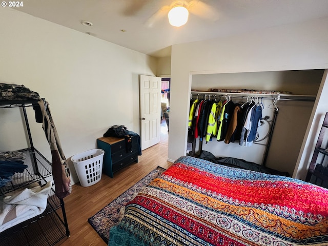 bedroom featuring hardwood / wood-style flooring, ceiling fan, and a closet