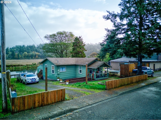 view of front of property with a water view