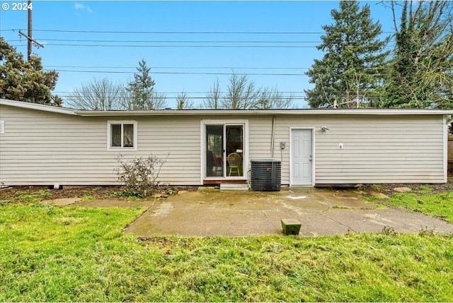 rear view of house with a yard, a patio area, and central air condition unit