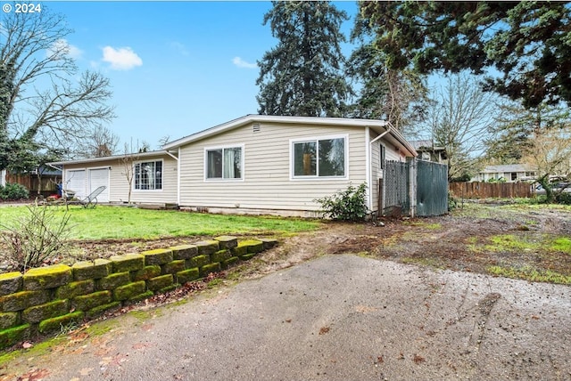 single story home with a front yard and a garage