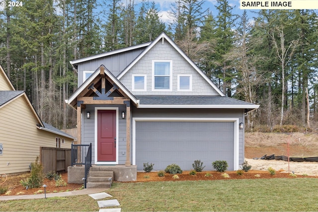 view of front of home with a garage and a front lawn