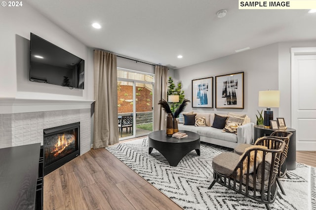 living room with a fireplace and hardwood / wood-style floors