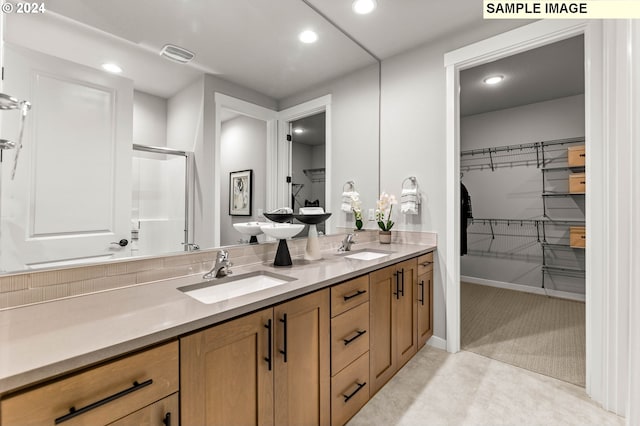 bathroom with vanity and a shower with shower door