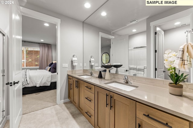 bathroom featuring vanity and an enclosed shower