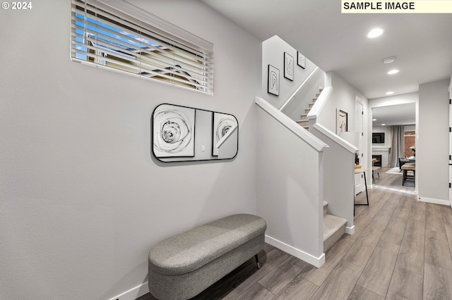 stairs with hardwood / wood-style floors