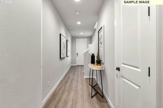 corridor with light hardwood / wood-style flooring