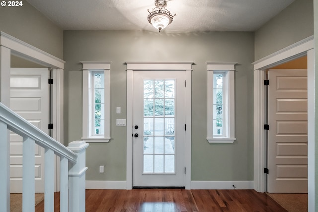 doorway to outside featuring hardwood / wood-style floors and a textured ceiling