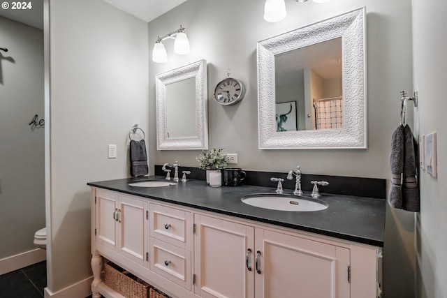 bathroom featuring tile patterned flooring, vanity, and toilet