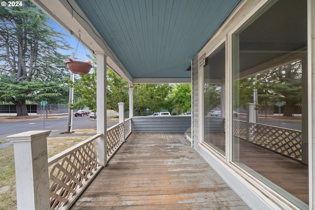 wooden terrace featuring covered porch