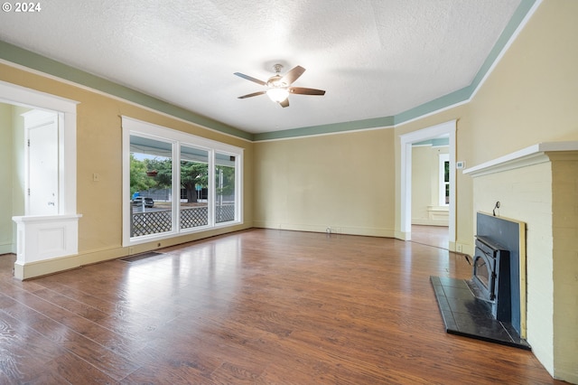 unfurnished living room featuring ceiling fan, dark hardwood / wood-style flooring, and a textured ceiling