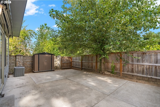 view of patio featuring central air condition unit and a storage unit