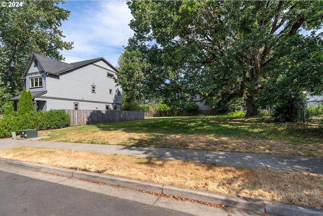 view of side of home featuring a yard