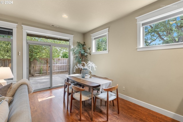 dining space with hardwood / wood-style flooring