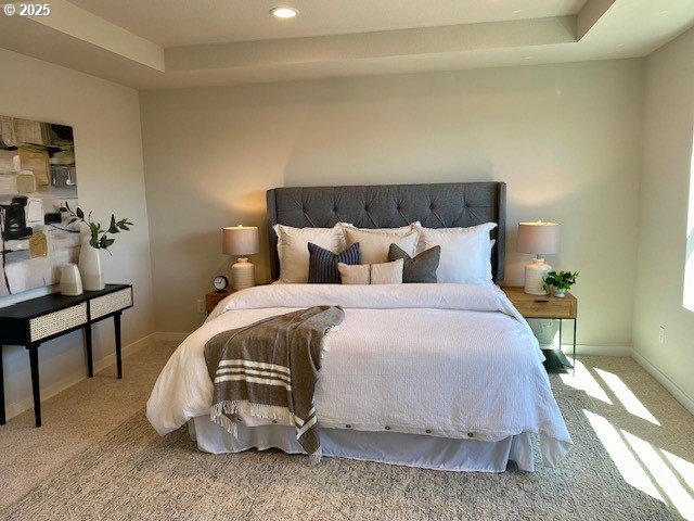 carpeted bedroom with baseboards, a tray ceiling, and recessed lighting