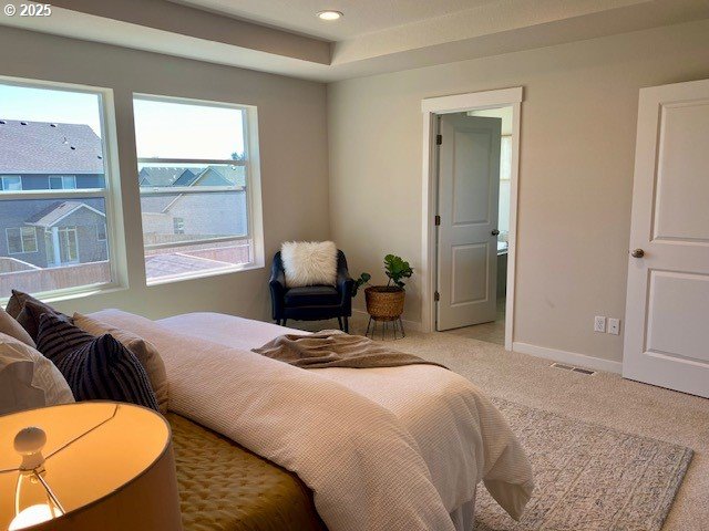 bedroom with visible vents, light carpet, baseboards, and recessed lighting