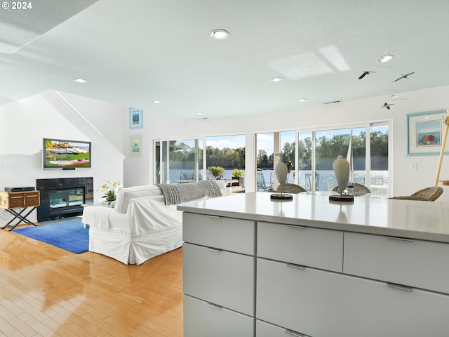 kitchen featuring light hardwood / wood-style floors and a tile fireplace