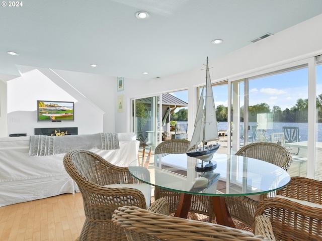 dining area with a healthy amount of sunlight and hardwood / wood-style flooring