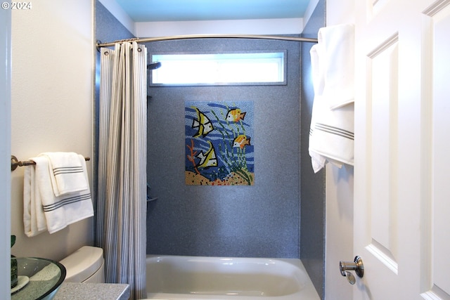 bathroom with shower / bath combo and toilet