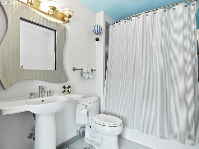 bathroom featuring toilet and tile flooring