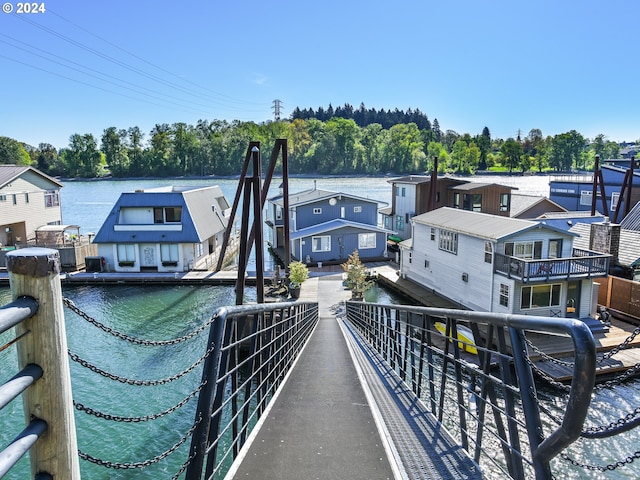 dock area with a water view and a balcony