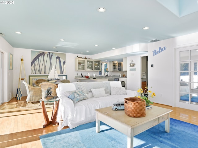 living room with hardwood / wood-style floors and washer / dryer