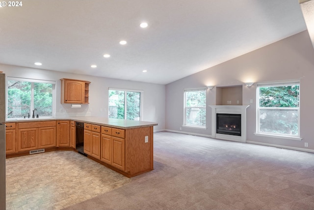 kitchen featuring kitchen peninsula, lofted ceiling, and light carpet