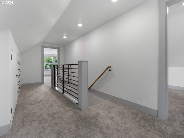 stairway with carpet and vaulted ceiling