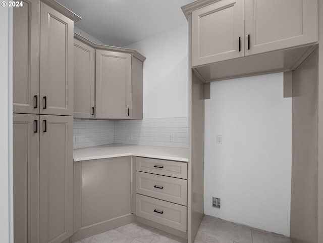 kitchen featuring tasteful backsplash, light tile patterned floors, and gray cabinets