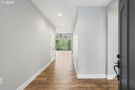 corridor with hardwood / wood-style floors