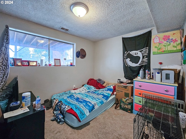 carpeted bedroom with a textured ceiling