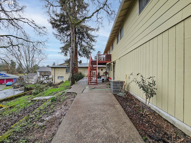 view of yard featuring a wooden deck and central AC