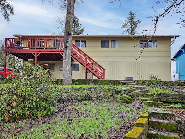 rear view of house featuring a deck