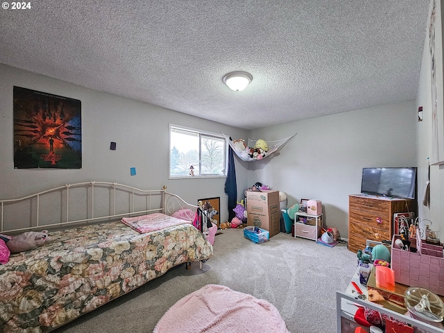 carpeted bedroom featuring a textured ceiling