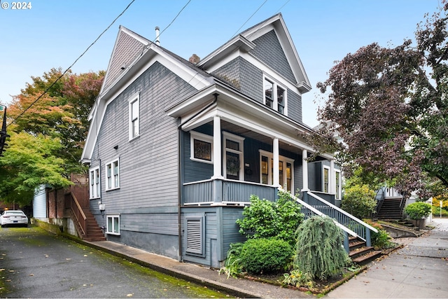 view of front of house featuring covered porch and a garage