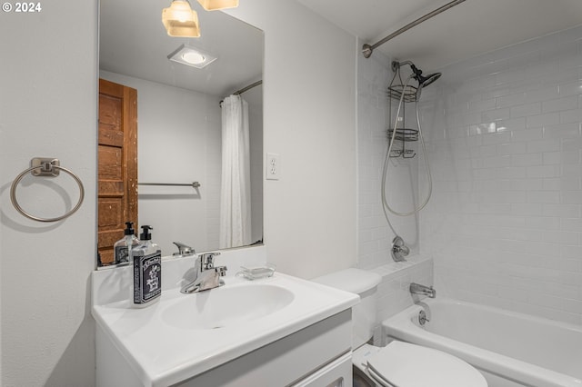 full bathroom featuring vanity, shower / tub combo, and toilet