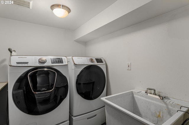 washroom featuring sink and washer and clothes dryer