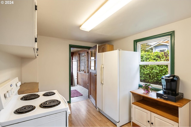 kitchen with light hardwood / wood-style floors, white appliances, white cabinets, and a healthy amount of sunlight