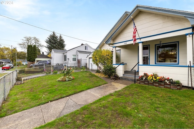 bungalow with covered porch and a front lawn