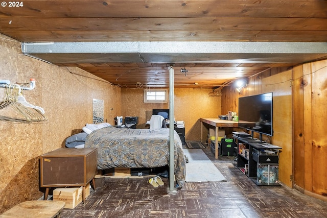 bedroom featuring wooden ceiling and wooden walls