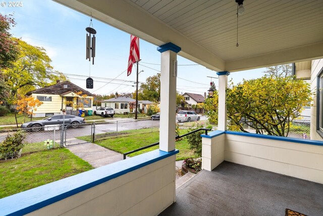 bungalow-style house with covered porch and a front lawn