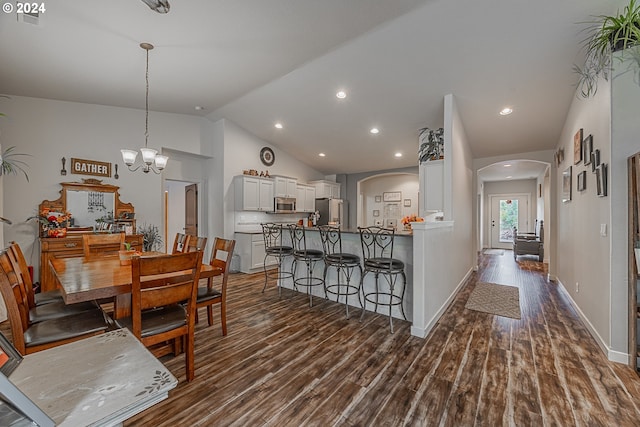 1843 Shelley Rd, Coquille, OR 97423 - dining space featuring arched walkways, dark wood-style floors, vaulted ceiling, baseboards, and recessed lighting