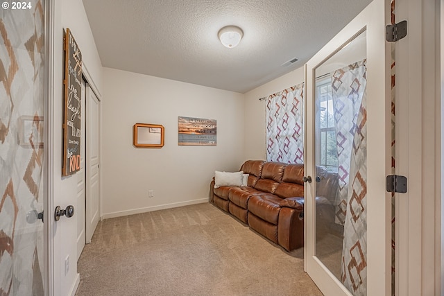 1843 Shelley Rd, Coquille, OR 97423 - sitting room with light colored carpet, a textured ceiling, baseboards, and french doors