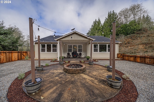 rear view of house featuring a fire pit and a patio area