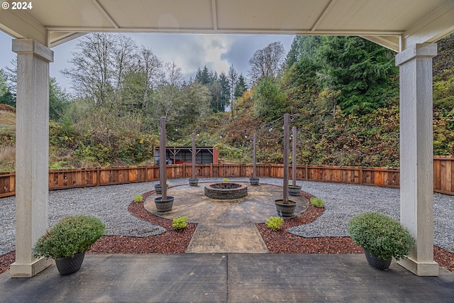 1843 Shelley Rd, Coquille, OR 97423 - fenced backyard featuring a fire pit, a patio area, and view of scattered trees