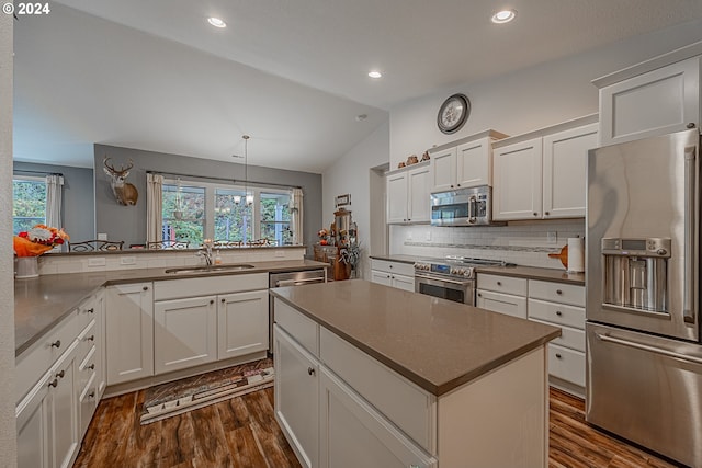 1843 Shelley Rd, Coquille, OR 97423 - kitchen featuring stainless steel appliances, a sink, vaulted ceiling, dark wood-style flooring, and tasteful backsplash