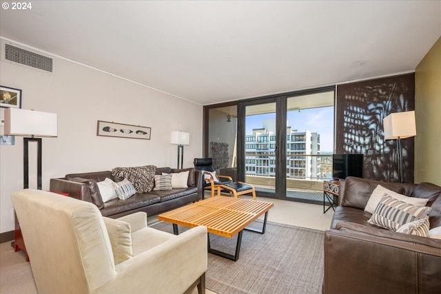 carpeted living room featuring floor to ceiling windows