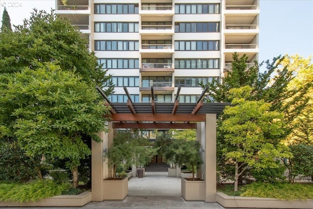 view of home's community featuring a pergola and a patio