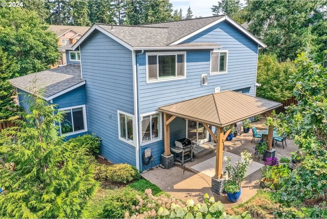 rear view of house featuring central air condition unit and a patio area